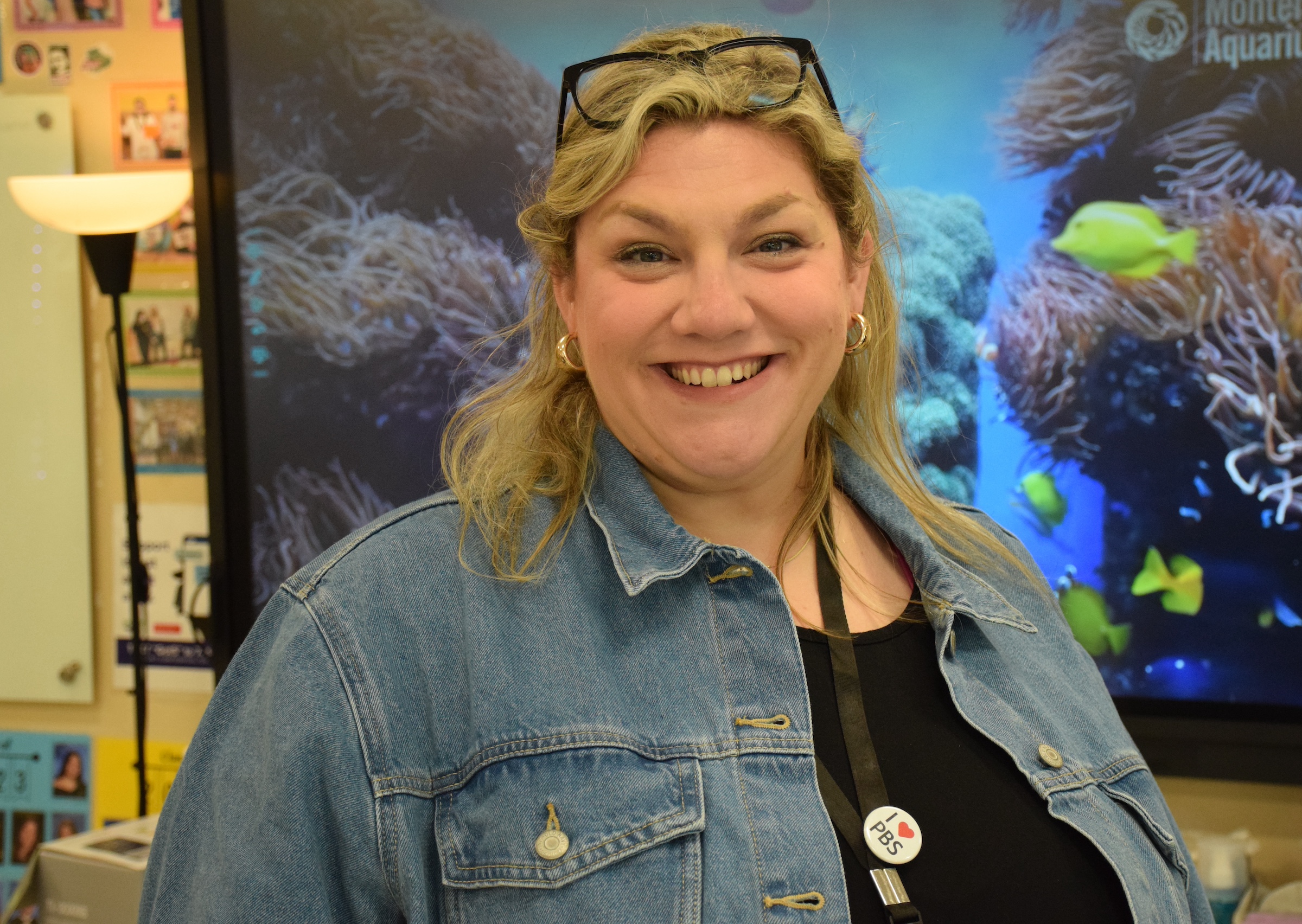 woman wearing denim jacket smiling
